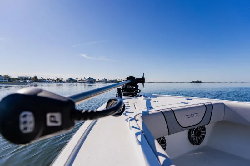  Yacht Photos Pics 2024 Dorado 25 boat on calm water under clear blue sky.