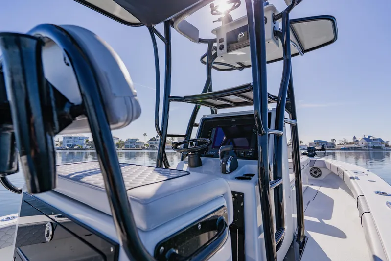  Yacht Photos Pics 2024 Dorado 25 boat interior with modern helm and seating on calm water.