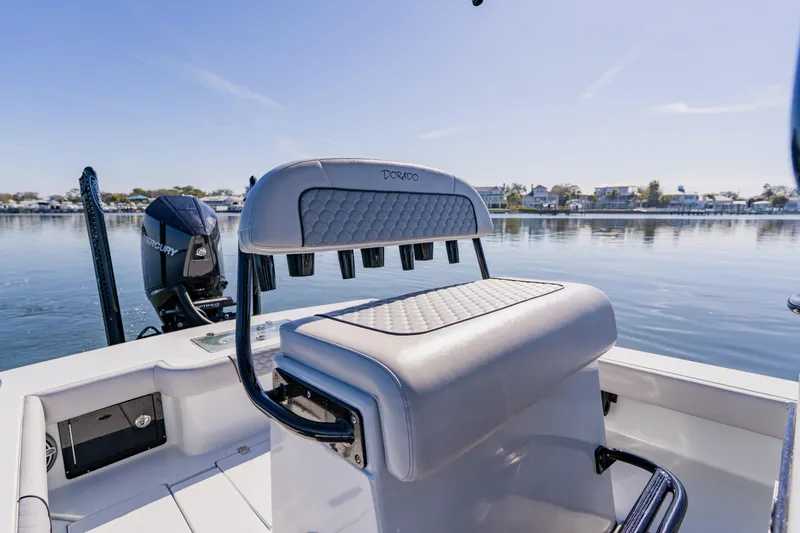  Yacht Photos Pics 2024 Dorado 25 boat interior with Mercury engine on calm water.