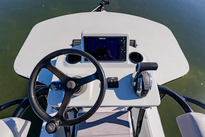  Yacht Photos Pics 2024 Dorado 25 boat helm with steering wheel, control panel, and navigation display.