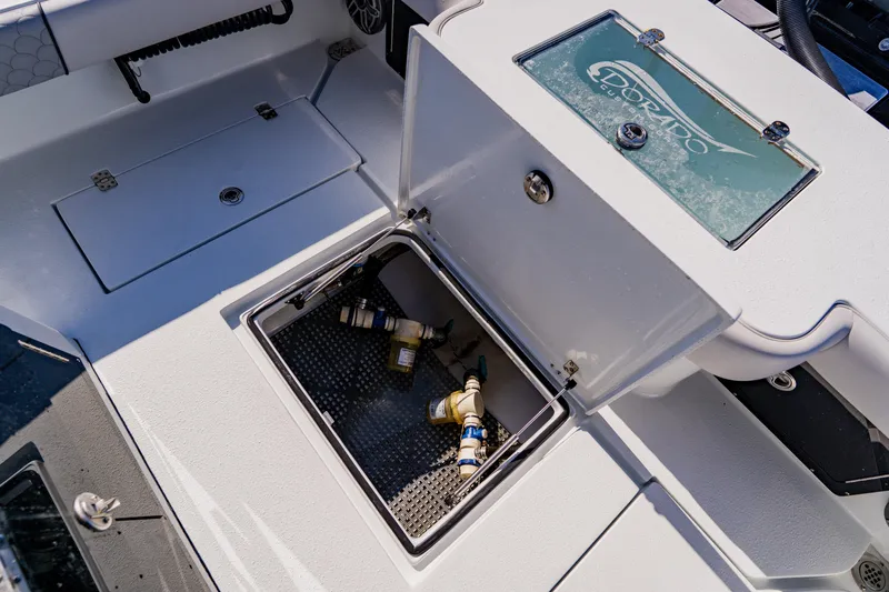  Yacht Photos Pics 2024 Dorado 25 boat storage compartment with open hatch and visible plumbing components.