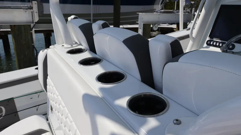  Yacht Photos Pics 2025 Yellowfin 39 Offshore boat interior with cup holders and cushioned seating.