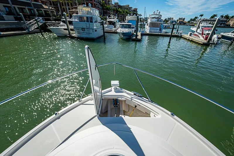 Exitevent Yacht Photos Pics 2017 Tiara Yacht Coupe docked in a sunny marina with sparkling water.