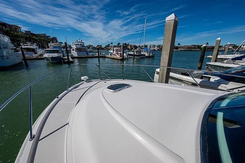 Exitevent Yacht Photos Pics 2017 Tiara Yacht coupe docked in a marina under a clear blue sky.