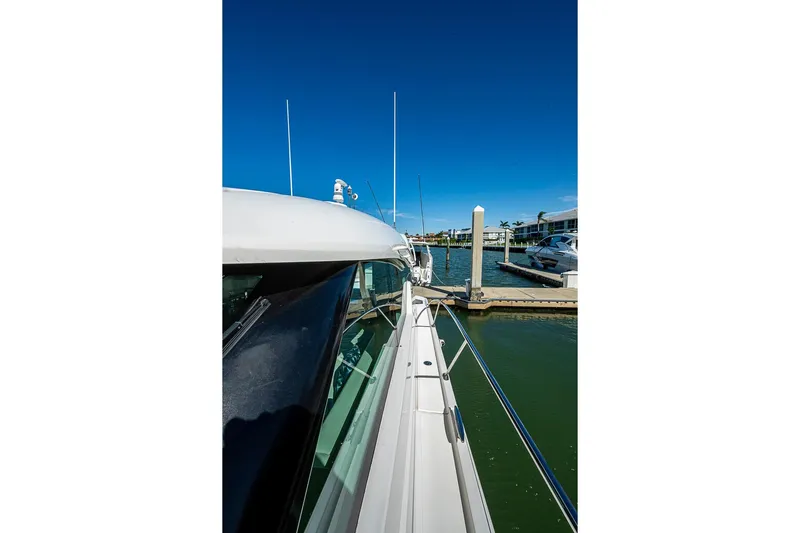 Exitevent Yacht Photos Pics 2017 Tiara Yacht Coupe docked at marina under clear blue sky.