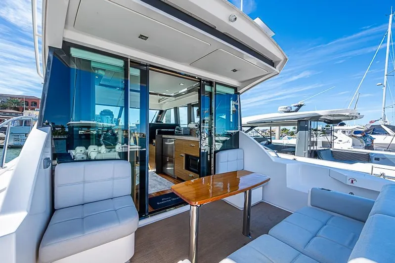 Exitevent Yacht Photos Pics 2017 Tiara Yacht Coupe with modern interior and outdoor seating, docked at a marina.