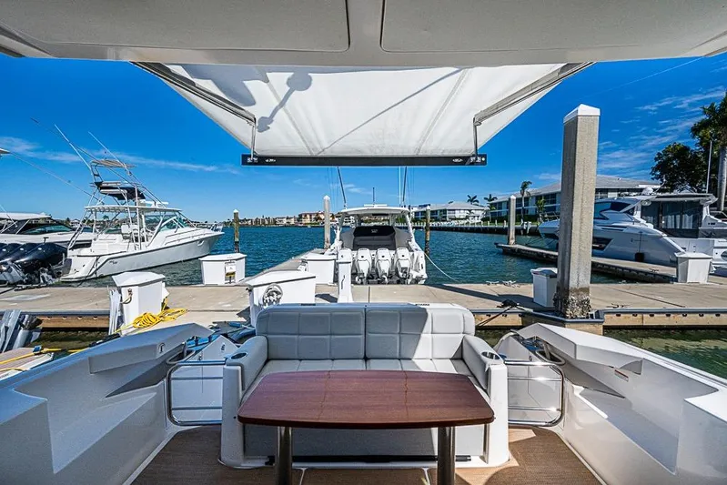 Exitevent Yacht Photos Pics 2017 Tiara Yacht Coupe docked at marina with seating and canopy.