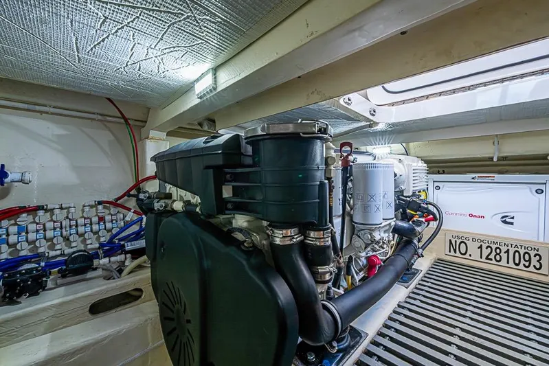 Exitevent Yacht Photos Pics Engine room of a 2017 Tiara Yacht Coupe, featuring Cummins Onan generator and wiring.