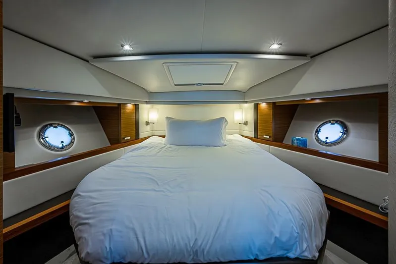 Exitevent Yacht Photos Pics Luxurious 2017 Tiara Yacht coupe bedroom with elegant bedding and porthole windows.