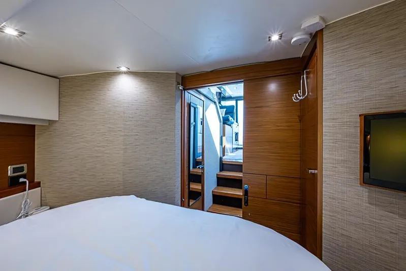 Exitevent Yacht Photos Pics Interior of 2017 Tiara Yacht coupe, featuring a cozy bedroom with modern wood finishes.
