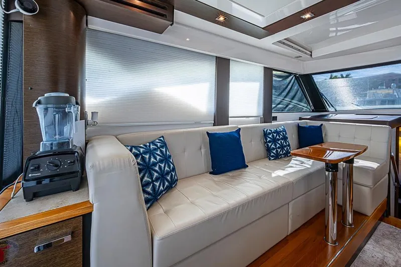 Exitevent Yacht Photos Pics Luxurious 2017 Tiara Yacht coupe interior with plush seating, blue cushions, and a sleek blender.
