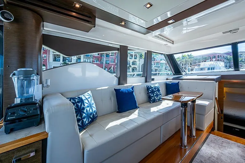 Exitevent Yacht Photos Pics Luxurious 2017 Tiara Yacht coupe interior with white seating, blue cushions, and modern design.