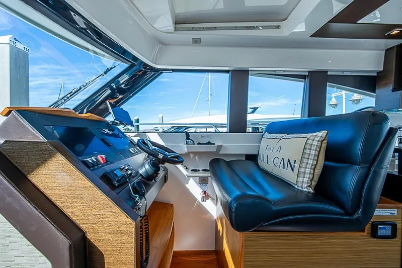 Exitevent Yacht Photos Pics Interior of 2017 Tiara Yacht Coupe with modern helm and leather seating.