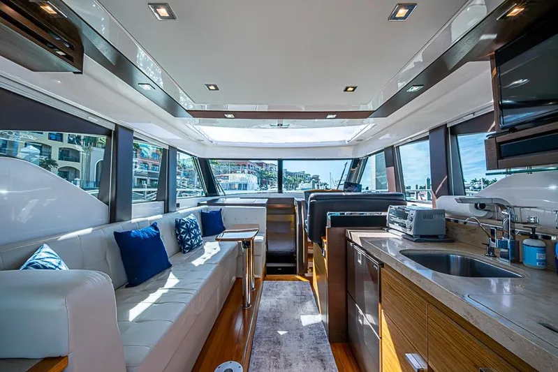 Exitevent Yacht Photos Pics Luxurious interior of 2017 Tiara Yacht coupe with modern kitchen and seating area.