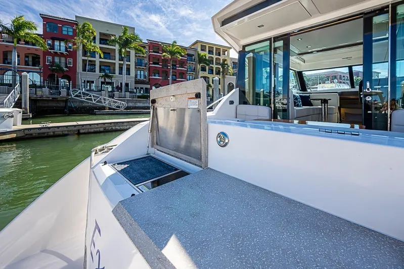 Exitevent Yacht Photos Pics 2017 Tiara Yacht Coupe docked near colorful waterfront buildings.