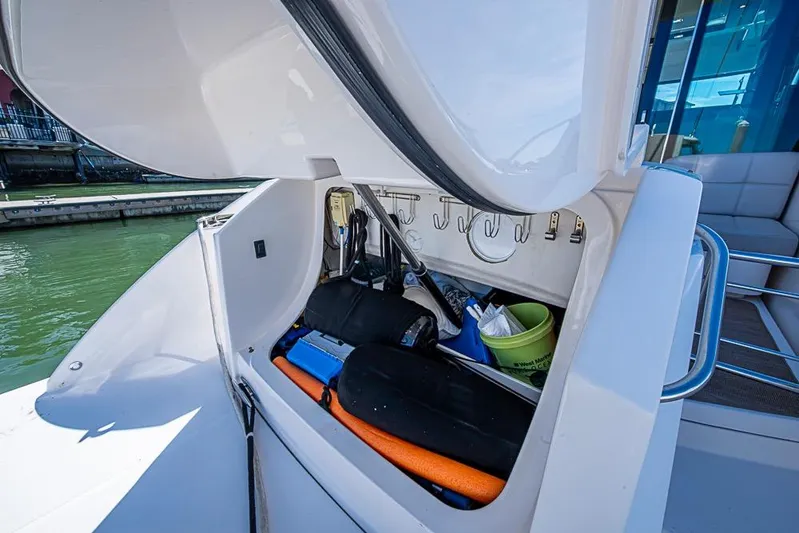 Exitevent Yacht Photos Pics 2017 Tiara Yacht coupe storage compartment with various boating accessories and equipment.