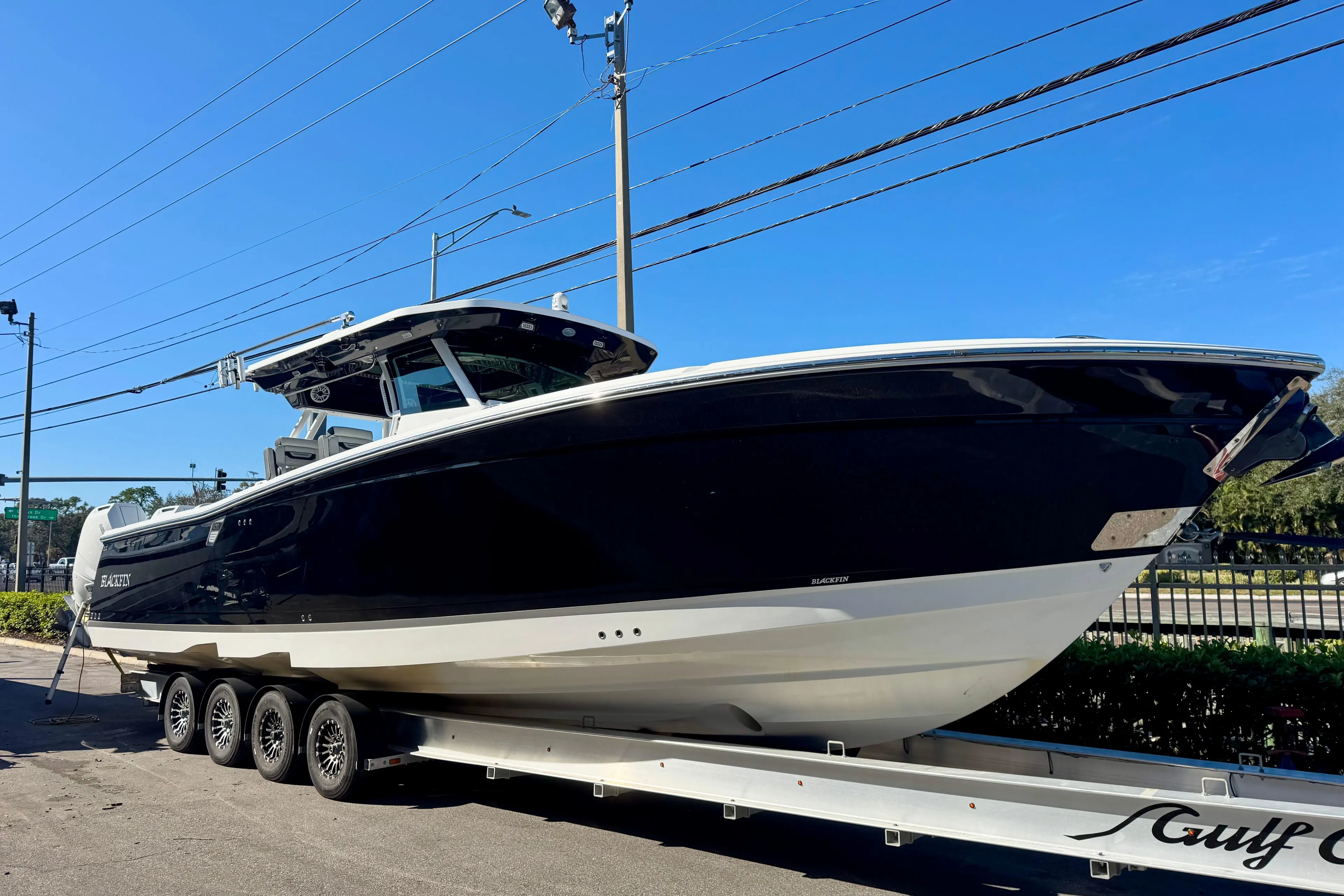 2024 Blackfin 400 CC boat on trailer under clear blue sky.