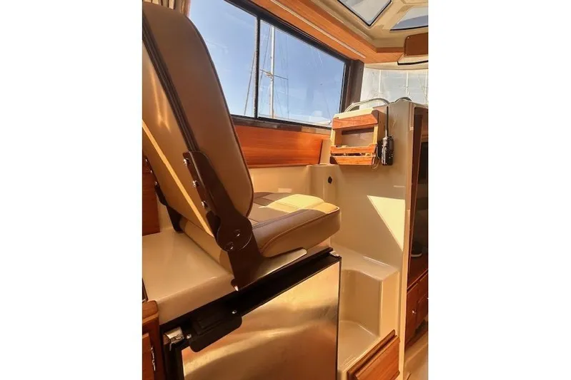  Yacht Photos Pics 2024 Ranger Tugs R-27 interior with seating and compact kitchen area.