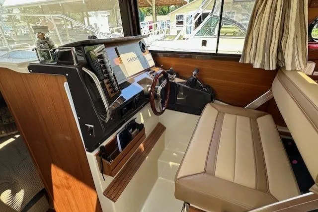  Yacht Photos Pics 2024 Ranger Tugs R-27 helm with modern controls and comfortable seating.