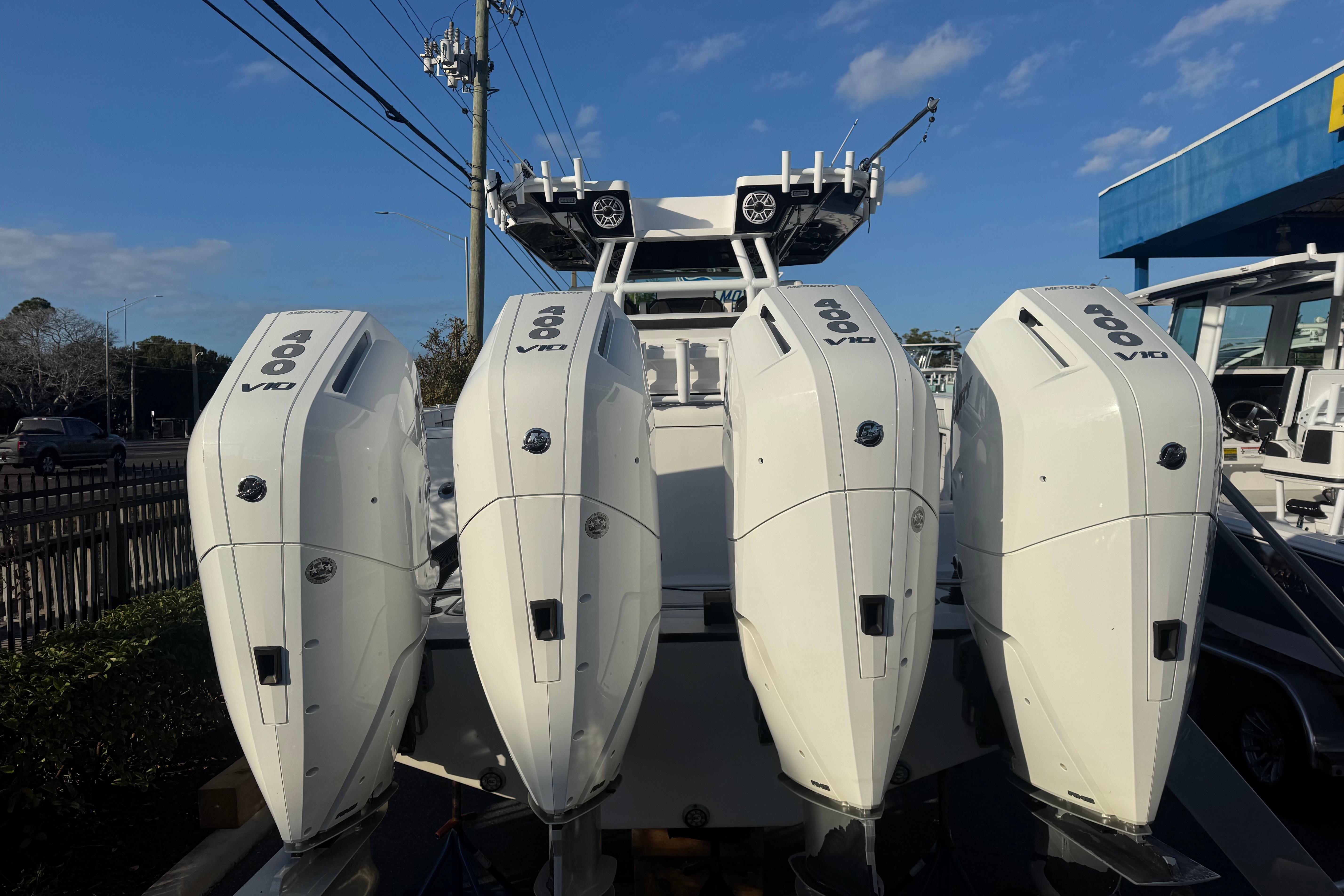 2026 Blackfin 400 CC boat with four powerful V10 engines, docked under a clear sky.
