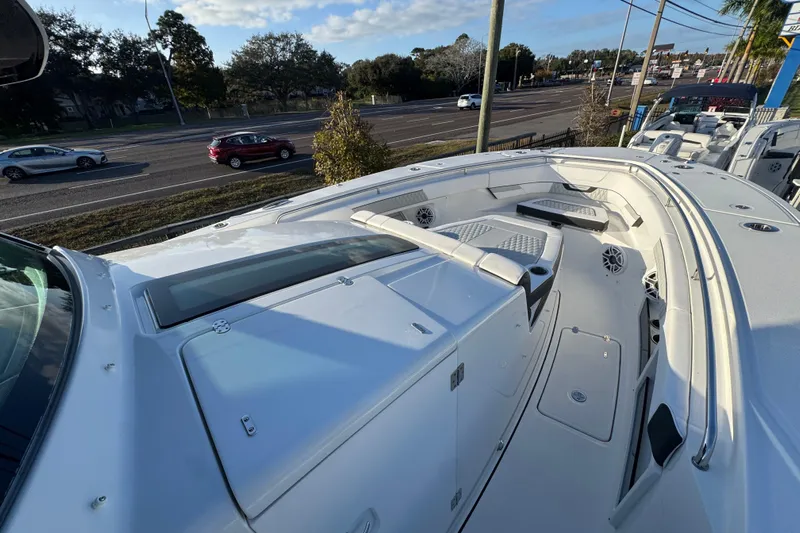  Yacht Photos Pics 2026 Blackfin 400 CC boat with spacious deck and seating, parked near a road.