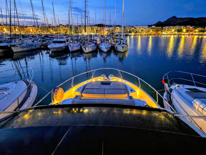  Yacht Photos Pics Luxurious 2020 Cranchi E 52S Evoluzione yacht docked at a marina during twilight.