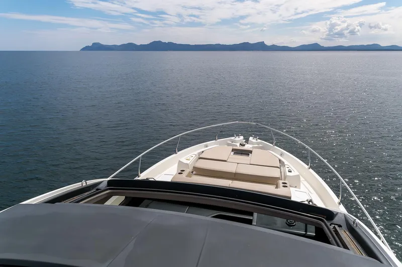  Yacht Photos Pics Cranchi E 52S Evoluzione 2020 yacht cruising on calm sea with distant mountains.