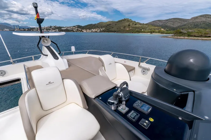  Yacht Photos Pics Luxurious 2020 Cranchi E 52S Evoluzione yacht helm with scenic coastal backdrop.