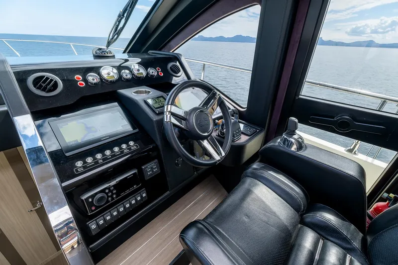  Yacht Photos Pics Helm of 2020 Cranchi E 52S Evoluzione yacht with leather seat and modern controls.