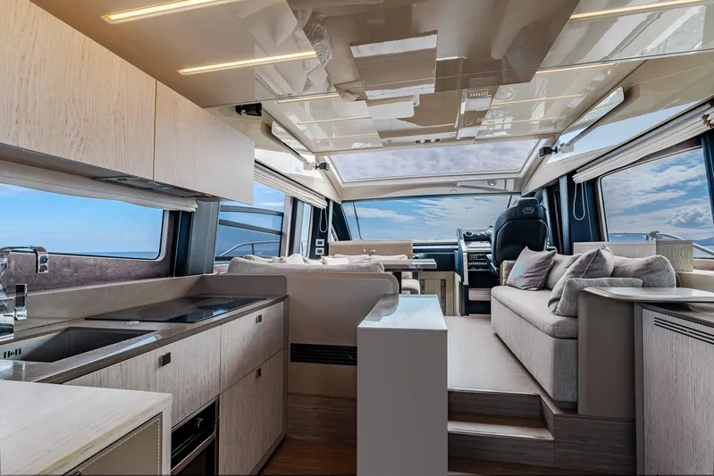  Yacht Photos Pics Luxurious interior of 2020 Cranchi E 52S Evoluzione yacht with modern kitchen and seating area.