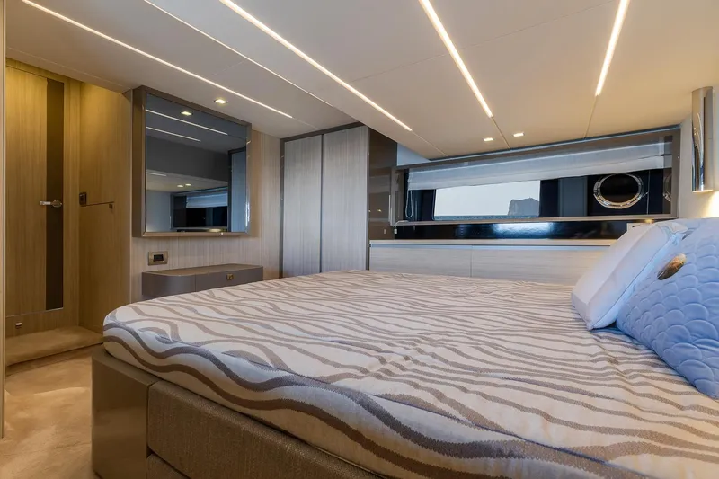  Yacht Photos Pics Luxurious bedroom interior of 2020 Cranchi E 52S Evoluzione yacht, featuring modern design and ambient lighting.