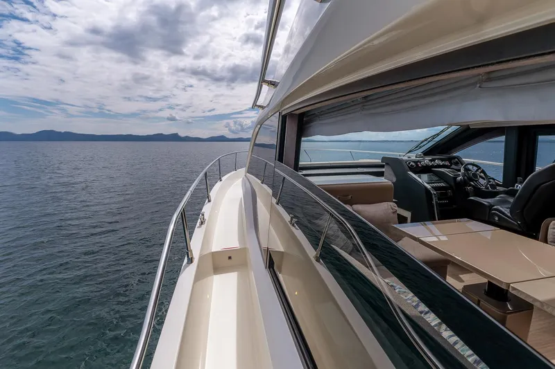  Yacht Photos Pics 2020 Cranchi E 52S Evoluzione yacht cruising on open water under a cloudy sky.