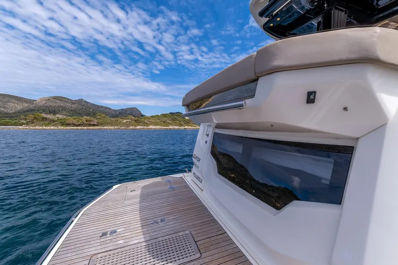  Yacht Photos Pics 2020 Cranchi E 52S Evoluzione yacht on serene water with scenic mountain backdrop.