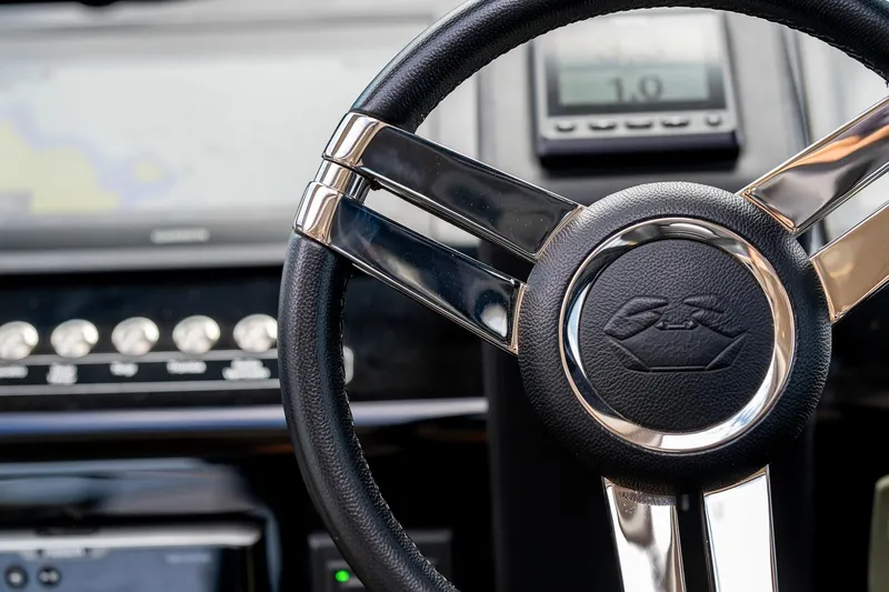  Yacht Photos Pics Steering wheel of 2020 Cranchi E 52S Evoluzione yacht, featuring sleek metallic design.
