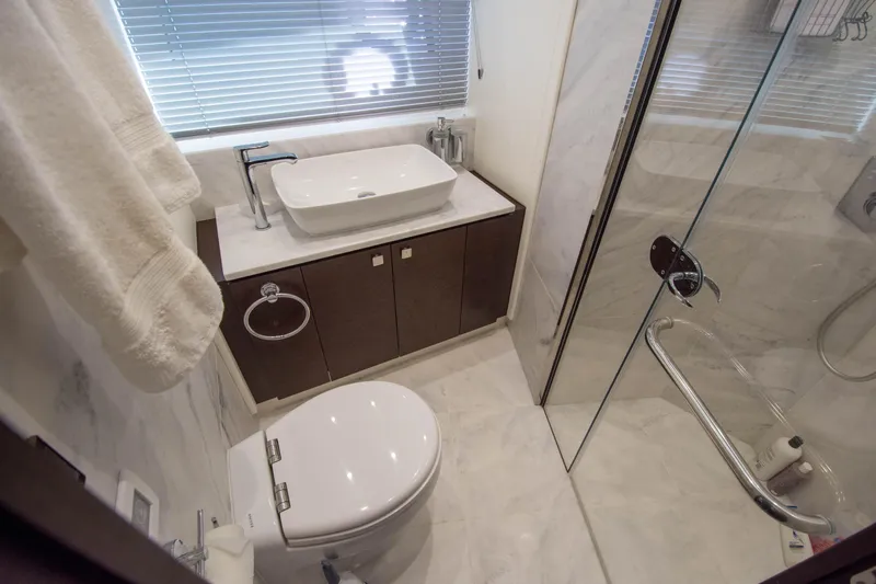  Yacht Photos Pics Luxurious bathroom in 2020 Sunseeker Predator 74 XPS yacht with modern fixtures and glass shower.