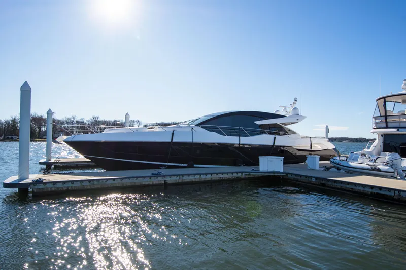  Yacht Photos Pics 2020 Sunseeker Predator 74 XPS yacht docked in sunny marina.