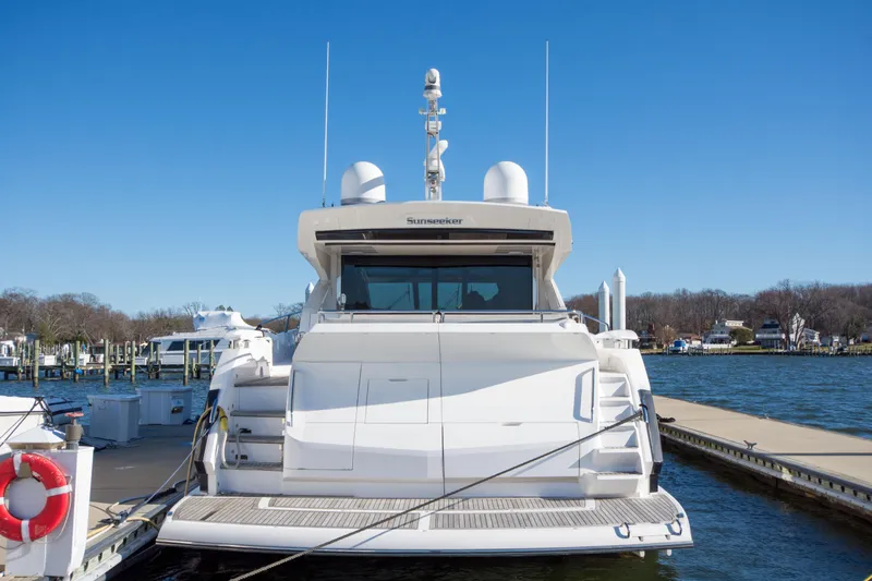  Yacht Photos Pics Sunseeker Predator 74 XPS 2020 yacht docked at marina under clear blue sky.