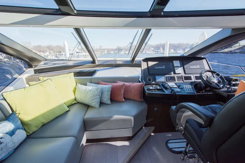  Yacht Photos Pics Luxurious interior of 2020 Sunseeker Predator 74 XPS yacht with plush seating and modern helm.