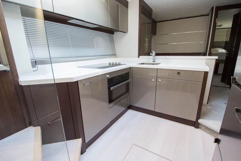  Yacht Photos Pics Modern kitchen interior on 2020 Sunseeker Predator 74 XPS yacht, featuring sleek cabinetry and appliances.