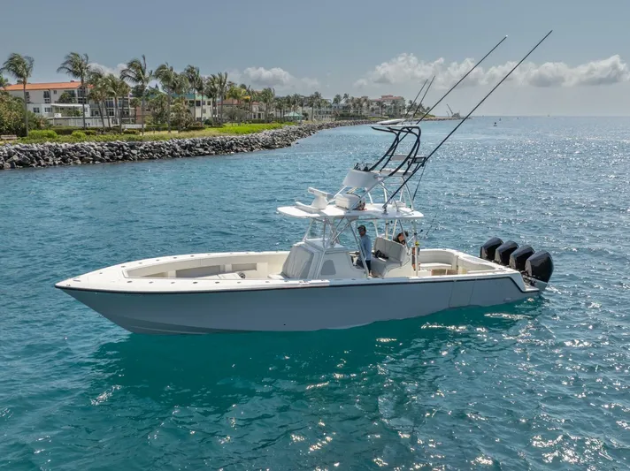 Zero Beach Yacht Photos Pics 2021 SeaVee 390Z boat on clear blue water near a tropical shoreline.