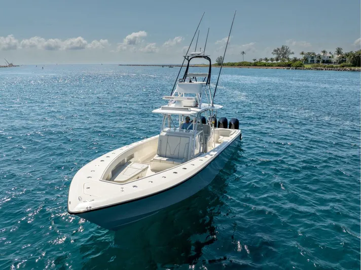 Zero Beach Yacht Photos Pics 2021 SeaVee 390Z boat on clear blue water, featuring sleek design and multiple outboard engines.