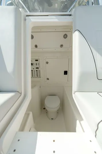 Zero Beach Yacht Photos Pics 2021 SeaVee 390Z boat interior with compact marine toilet and control panel.