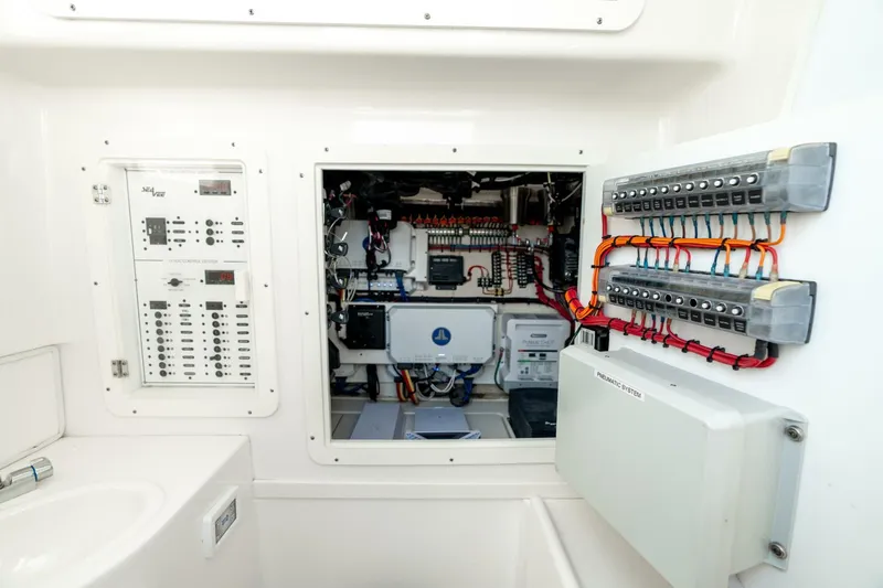 Zero Beach Yacht Photos Pics Electrical panel and wiring inside a 2021 SeaVee 390Z boat, showcasing organized marine electronics.