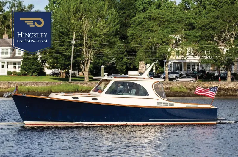 Gracious Yacht Photos Pics 2011 Hinckley Picnic Boat Mark III cruising on a river, certified pre-owned, with American flag.