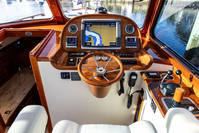 Gracious Yacht Photos Pics Hinckley Picnic Boat Mark III 2011 helm with navigation system and wooden steering wheel.