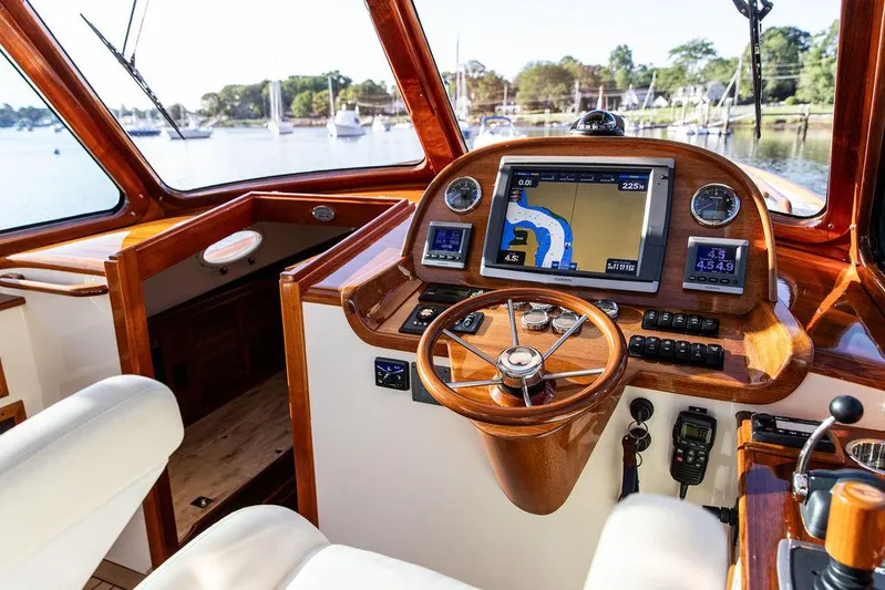Gracious Yacht Photos Pics Hinckley Picnic Boat Mark III 2011 helm with navigation system and wooden steering wheel.