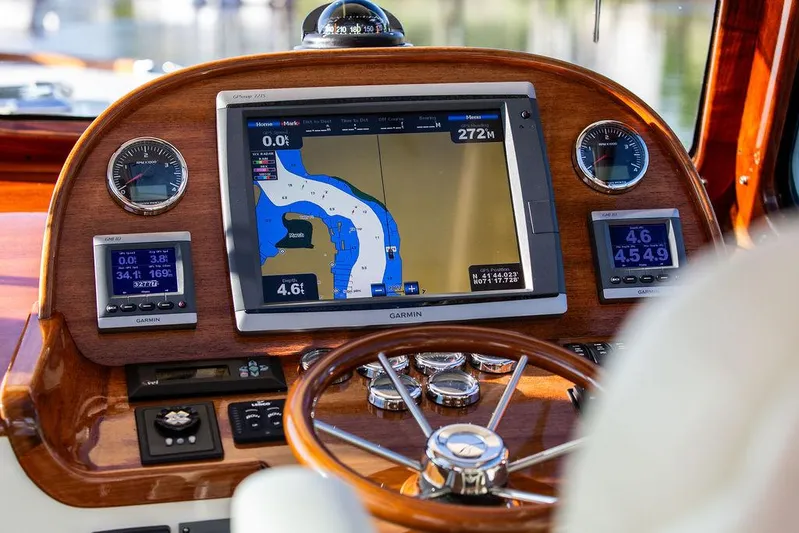 Gracious Yacht Photos Pics Hinckley Picnic Boat Mark III 2011 dashboard with Garmin navigation system and wooden steering wheel.