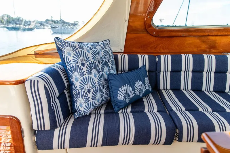 Gracious Yacht Photos Pics Interior of 2011 Hinckley Picnic Boat Mark III with striped seating and decorative pillows.