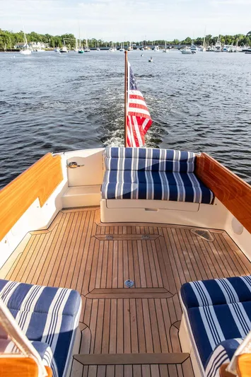 Gracious Yacht Photos Pics Hinckley Picnic Boat Mark III 2011 with striped seating, cruising on a scenic lake.