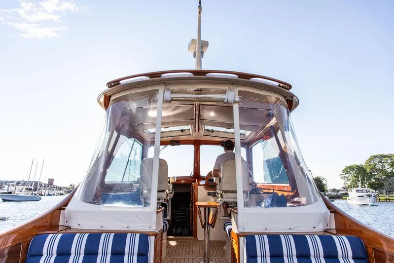 Gracious Yacht Photos Pics 2011 Hinckley Picnic Boat Mark III cruising on a sunny day, featuring striped seating.